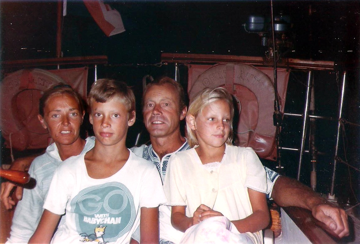 The family in the cockpit aboard Chricanto in the evening.