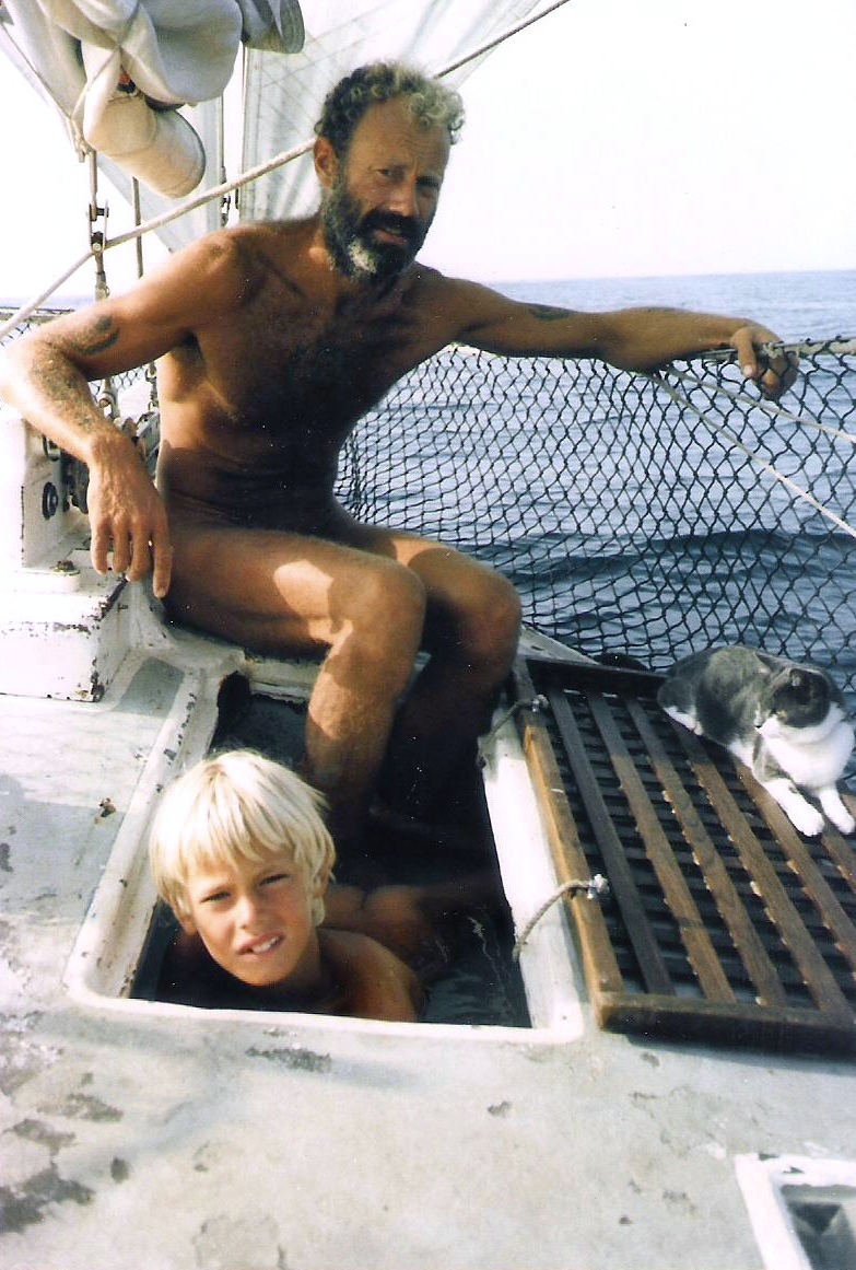 The skipper aboard Chricanto with Pusskins the cat on the lookout.
